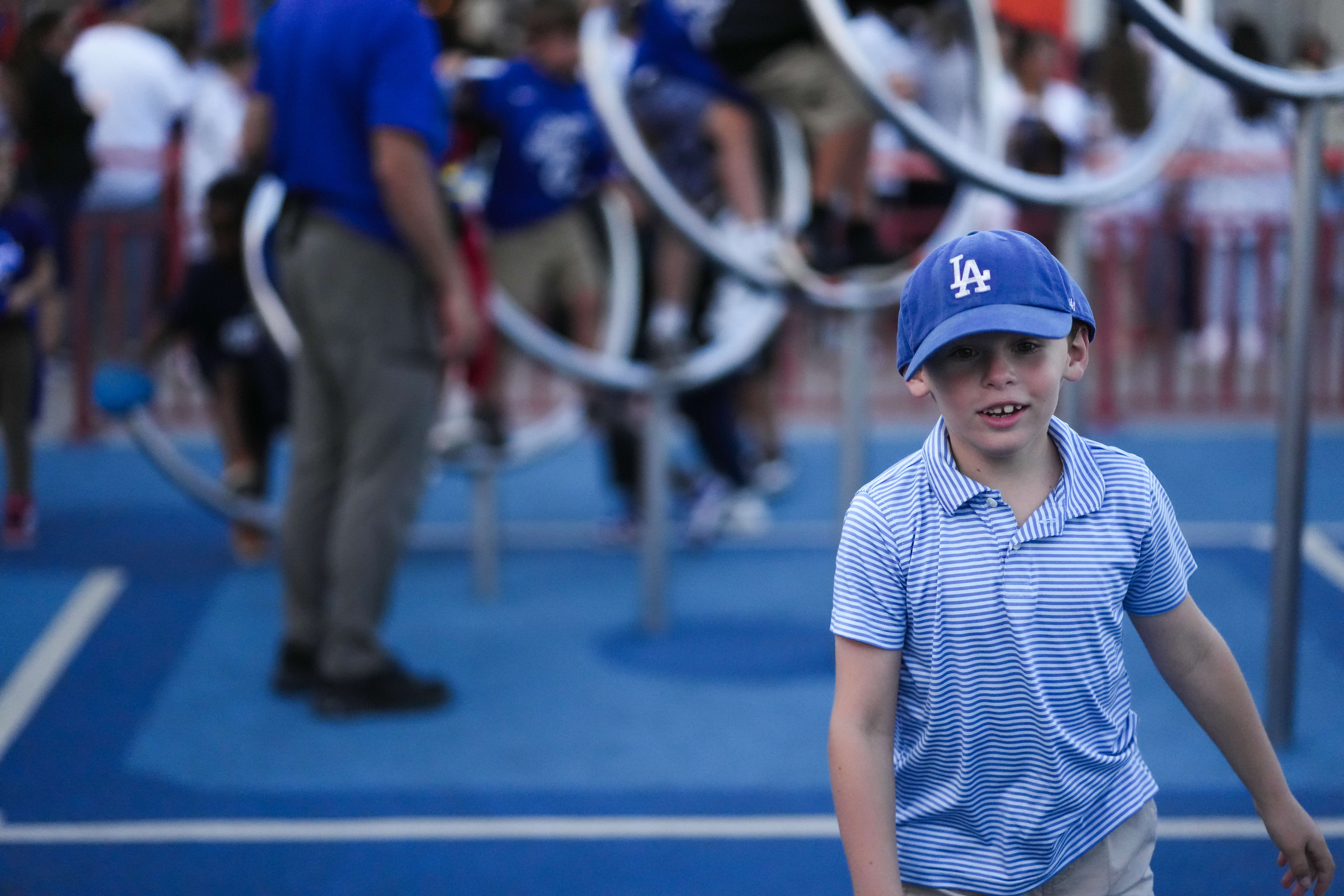 Kid in Dodgers cap on the field