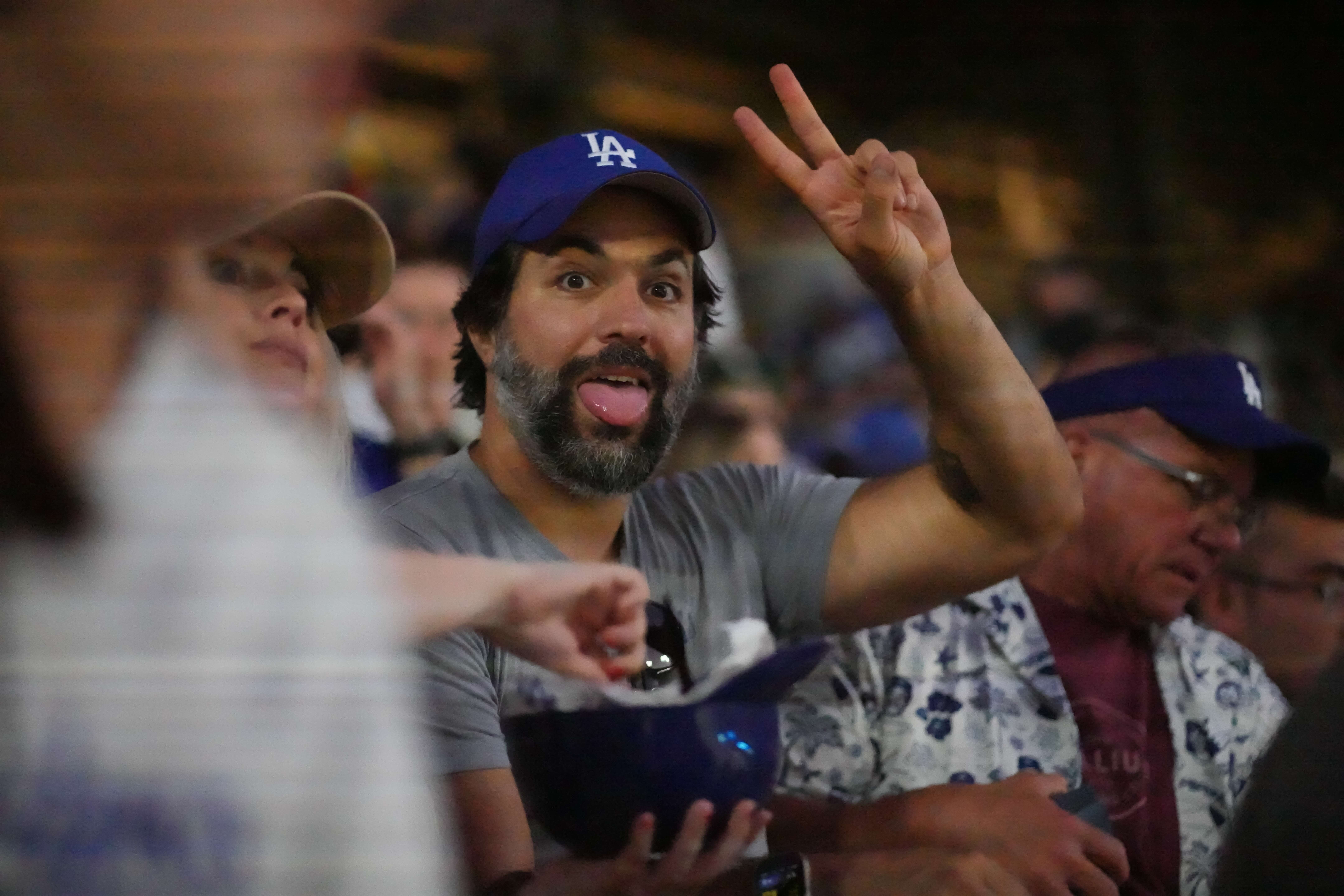 Fan in the crowd throwing peace signs