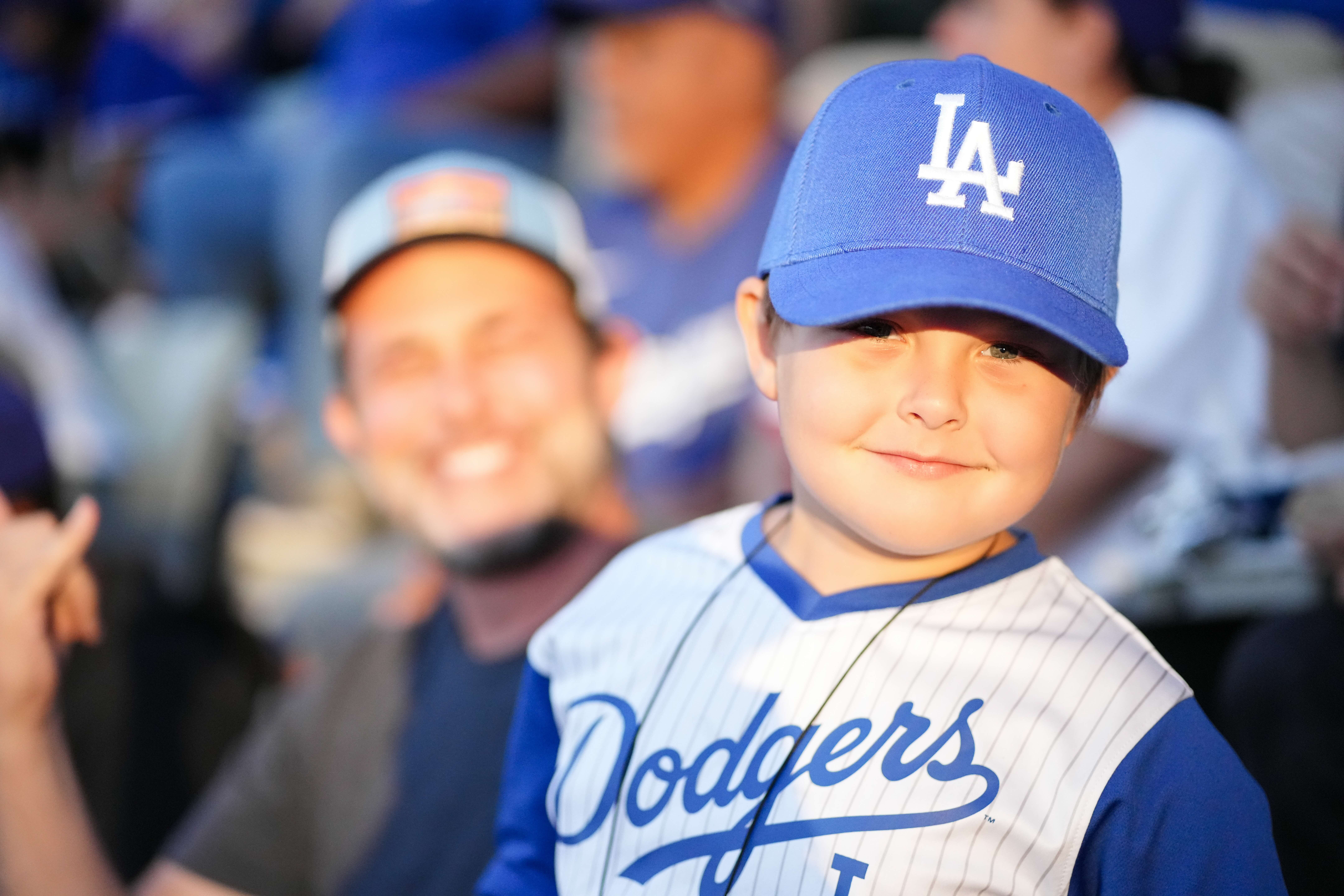 Kid in a Dodgers jersey and cap