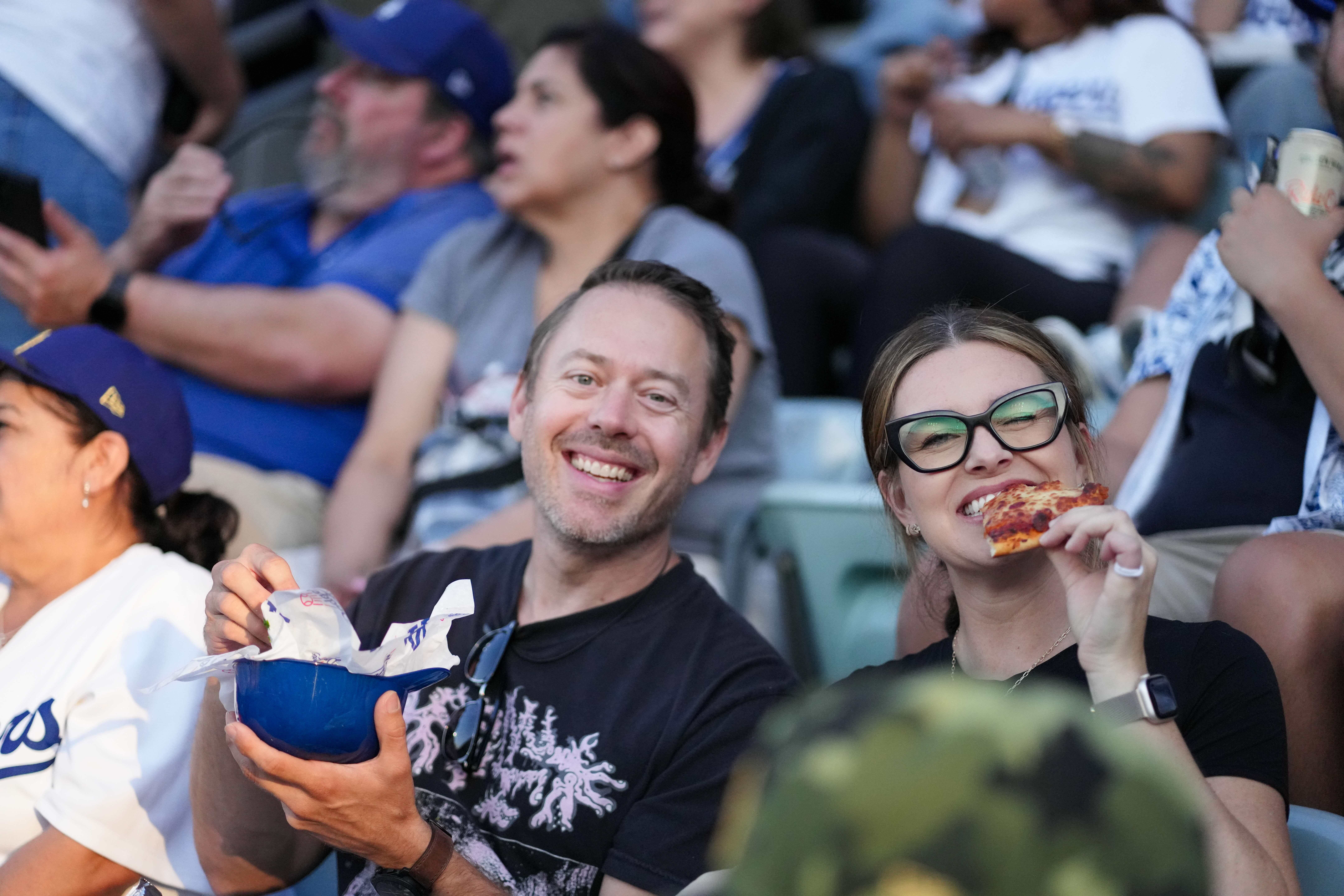 Couple sharing pizza and ice cream in the seats